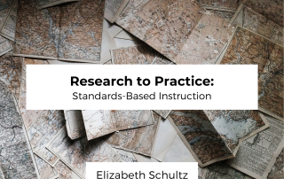 Image of folded unidentifiable maps on a table behind two white boxes that are centered. The first white box has the title of the post; Research to Practice: Standards-Based Instruction. The lower white box has the author name, Elizabeth Schultz.