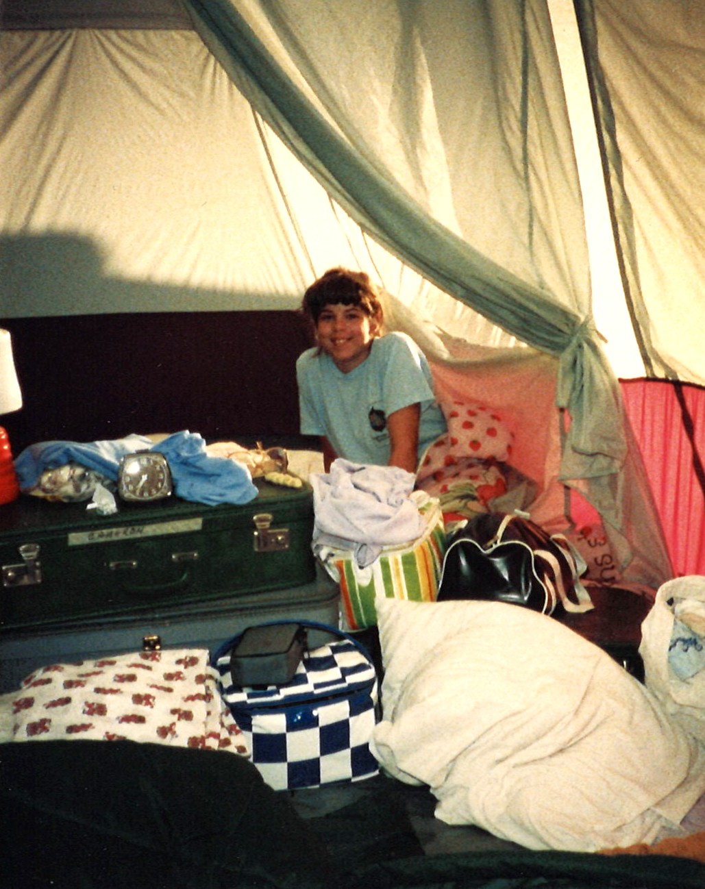 Kathy Melago as a kid in a tent with colorful bags